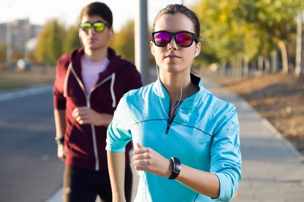 Beautiful couple running in the street. — Stock Photo, Image