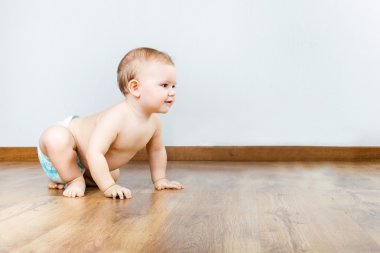 Evde oturan sevimli gülümseyen bebek.