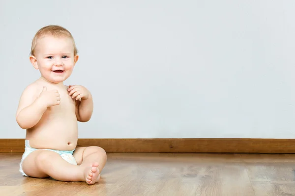 Cute smiling baby sitting at home. — Stock Photo, Image