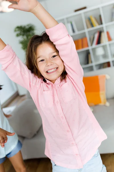 Beautiful child listening to music and dancing at home. — Stock Photo, Image