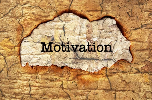 Motivation text på papper hål — Stockfoto