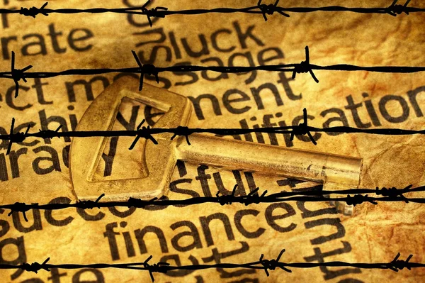 Finance and golden key against barbwire — Stock Photo, Image