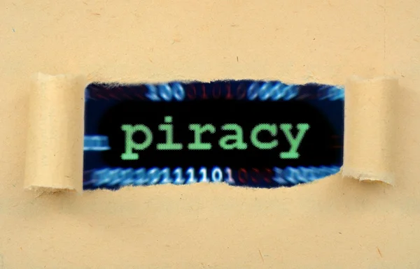 Piracy text on ripped paper — Stock Photo, Image