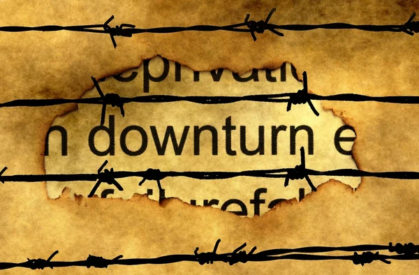 Downturn text on paper hole against barbwire — Stock Photo, Image