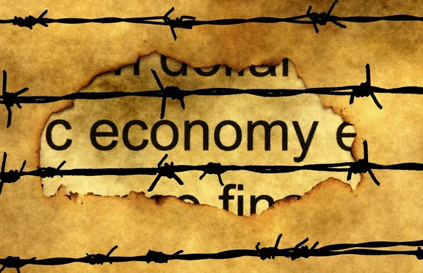 Economy text on paper hole against barbwire — Stock Photo, Image