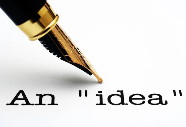 Fountain pen on idea text — Stock Photo, Image