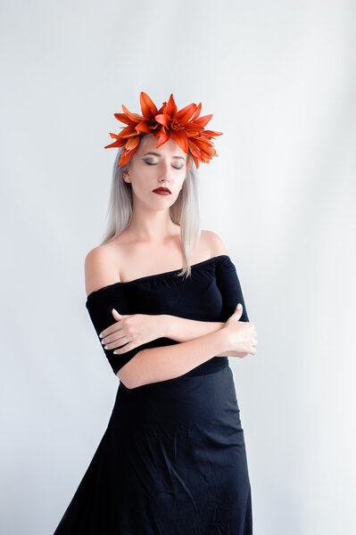 beautiful young girl in a black lenses with lilies