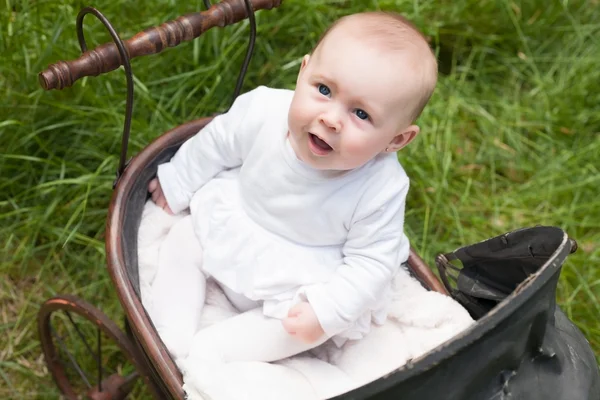 Baby is looking up in her pram — Stock Photo, Image