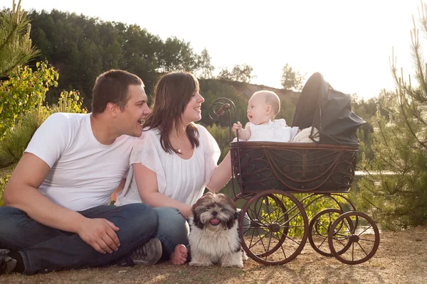 Happy family with vintage pram — Stock Photo, Image