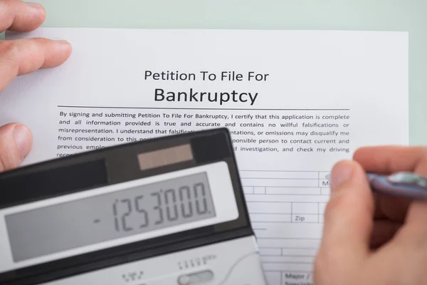 Calculator Over Bankruptcy Form — Stock Photo, Image