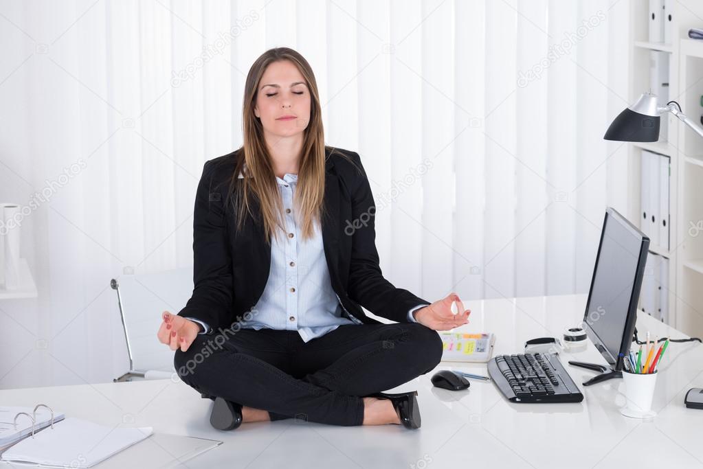 Businesswoman Doing Yoga In Office