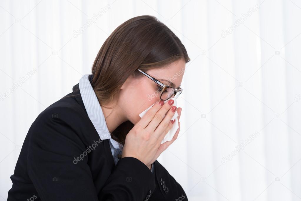 Businesswoman Blowing Nose