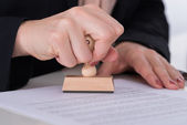 Businessperson Using Stamper On Document