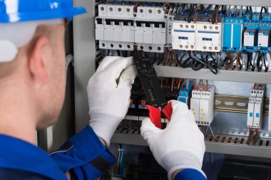 Electrician Repairing Fusebox clipart