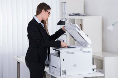 Businesswoman Using Printer Machine clipart