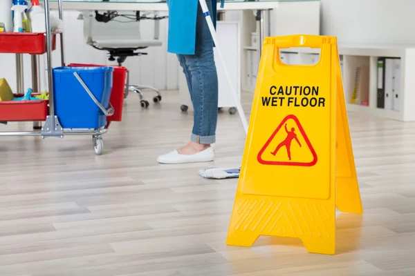 Janitor With Caution Sign — Stock Photo, Image