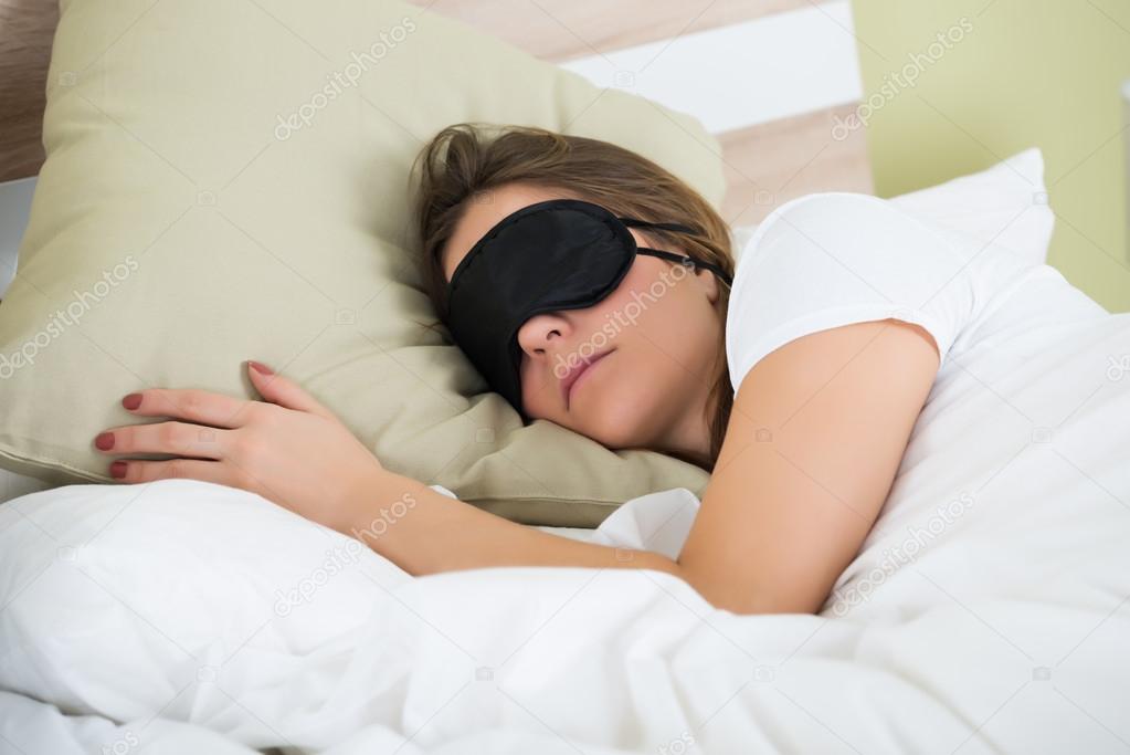 Woman Sleeping On Bed With An Eye Mask
