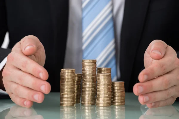 Businessperson Saving Pile Of Coins — Stock Photo, Image