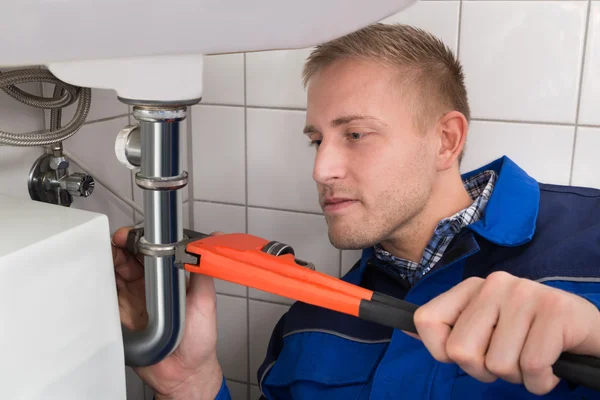 Plumber Fixing Sink In Kitchen — Stock Photo, Image