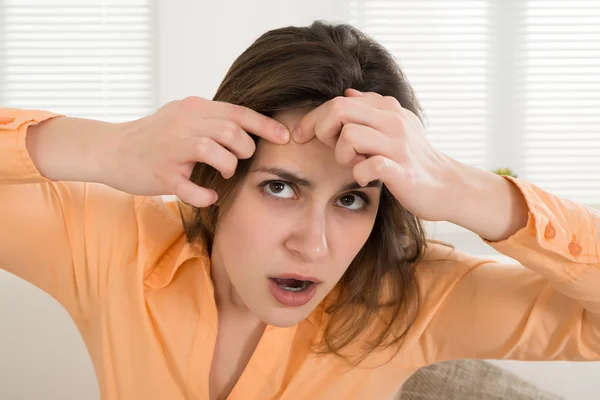 Mujer apretando espinilla — Foto de Stock