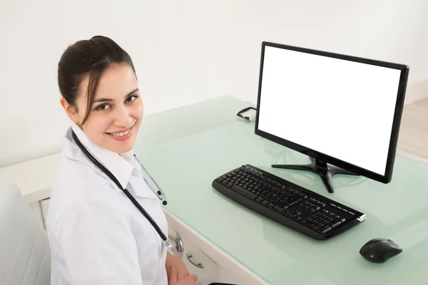 Female Doctor Sitting In Clinic — Stock Photo, Image