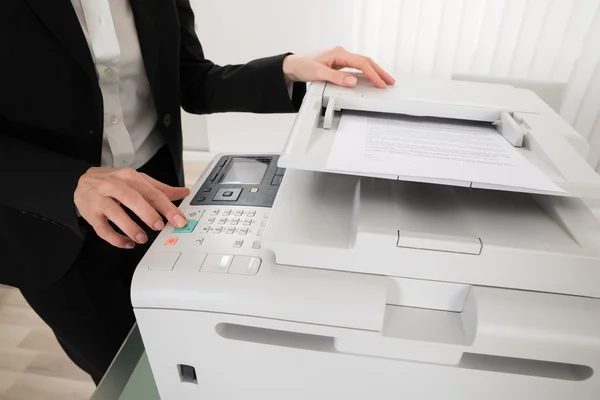 Businesswoman Pressing Printer Button — Stock Photo, Image
