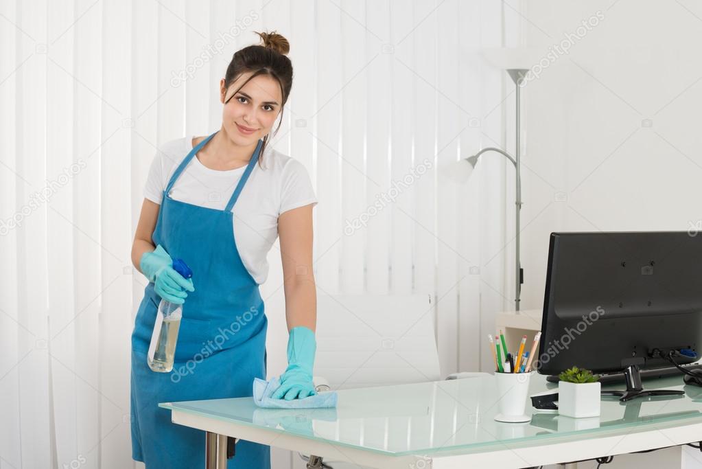 Female Janitor Wipe Desk
