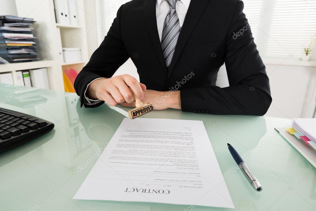 Businessman Stamping On Contract