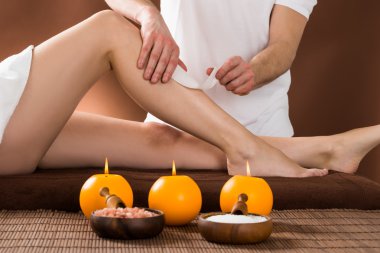 Woman Getting Her Leg Waxed clipart
