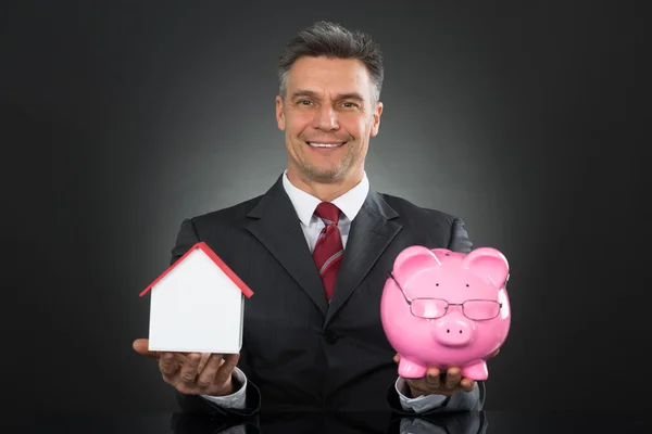 Businessman Piggy Bank And House — Stock Photo, Image