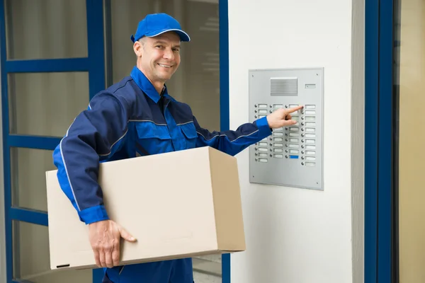 Delivery Man Pressing Button — Stock Photo, Image