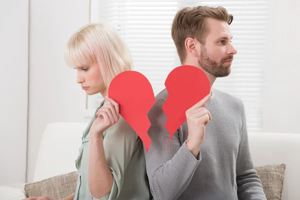 Casal segurando coração quebrado — Fotografia de Stock