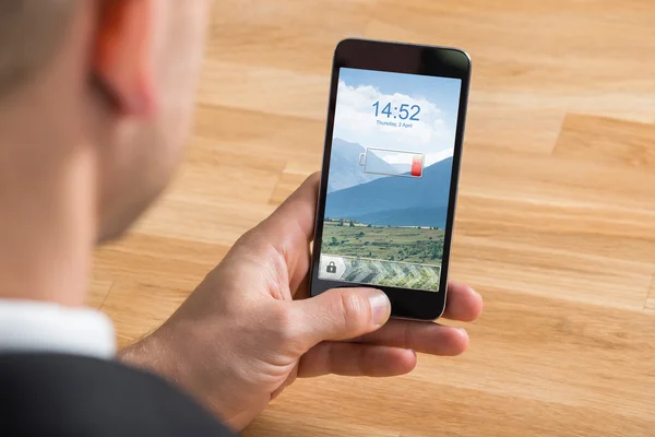 Businessman Holding Mobile Phone With Low Battery — Stock Photo, Image