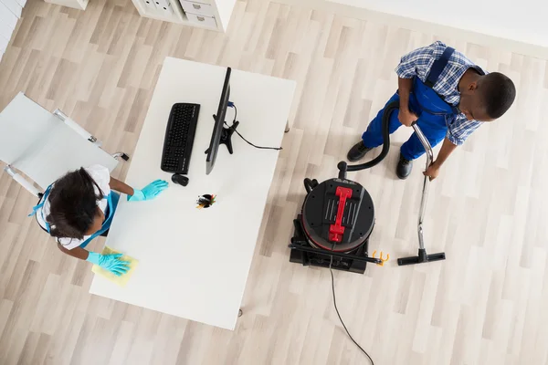 Male and Female Cleaning Office — стоковое фото