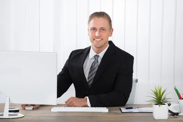 Empresário sorrindo no trabalho no escritório — Fotografia de Stock