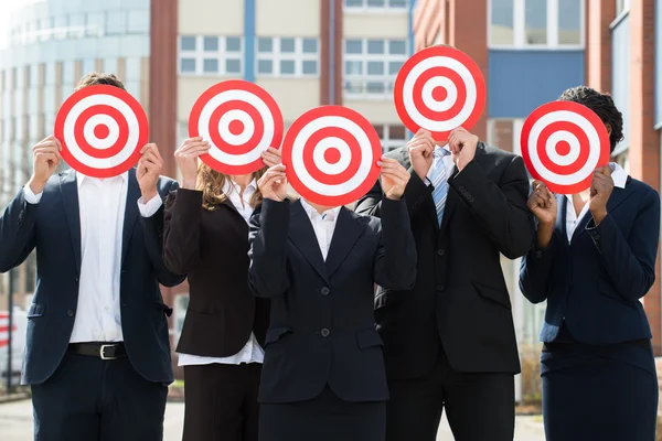 Businesspeople Hiding Faces With Dartboards — Stock Photo, Image