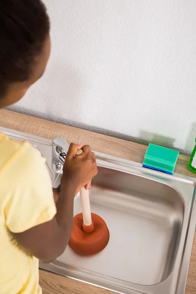 Woman Using Plunger In Sink — Stock Photo, Image