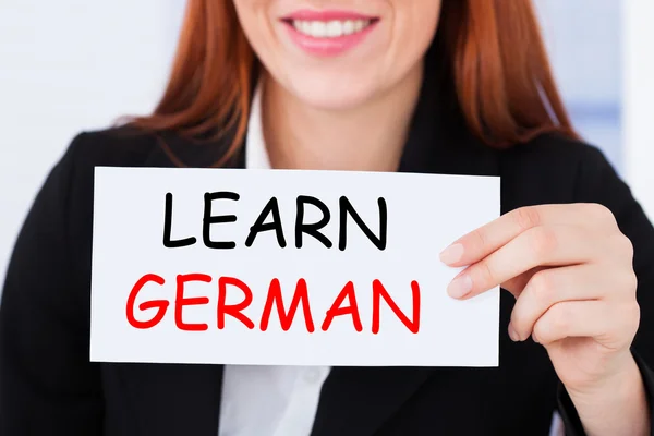 Businesswoman Holding Learn German Card — Stock Photo, Image