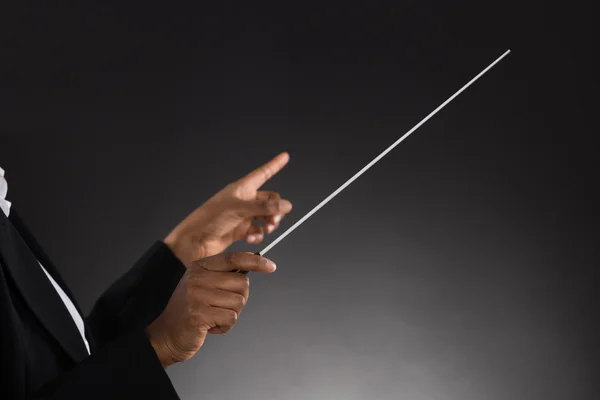 Female Orchestra Conductor Holding Baton — Stock Photo, Image