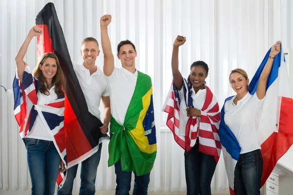 Vrienden met vlaggen uit verschillende landen — Stockfoto
