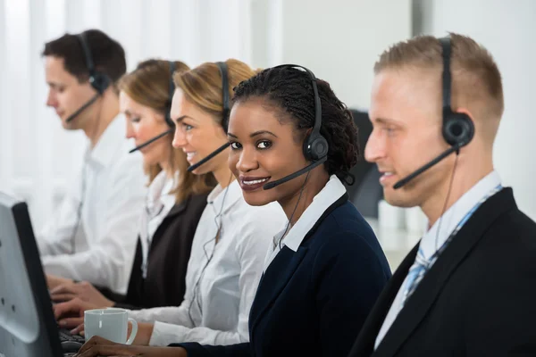 Geschäftsfrau arbeitet mit Kollegen im Callcenter — Stockfoto