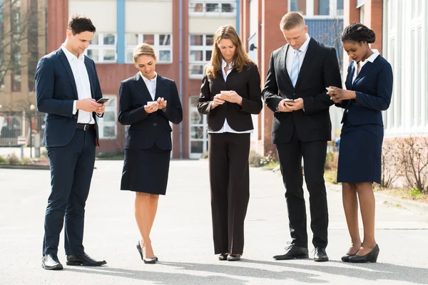 Üzletemberek mobiltelefon használata — Stock Fotó