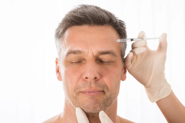 Hombre maduro obtener inyección en la cara —  Fotos de Stock
