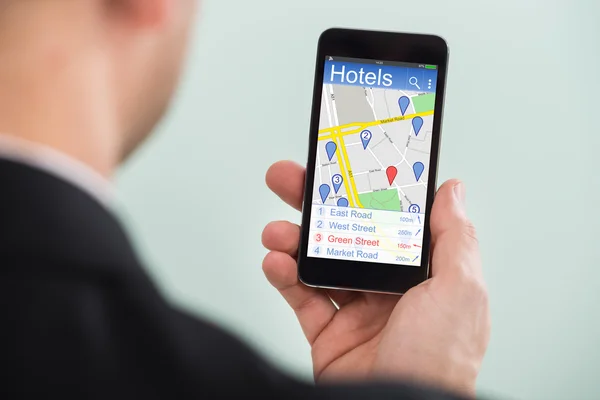 Person Searching Hotels On Smartphone