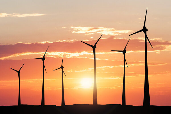 Windmill At Sunset Generating Electricity 