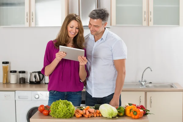 Couple Looking At Recipe On Digital Tablet — Stock Photo, Image