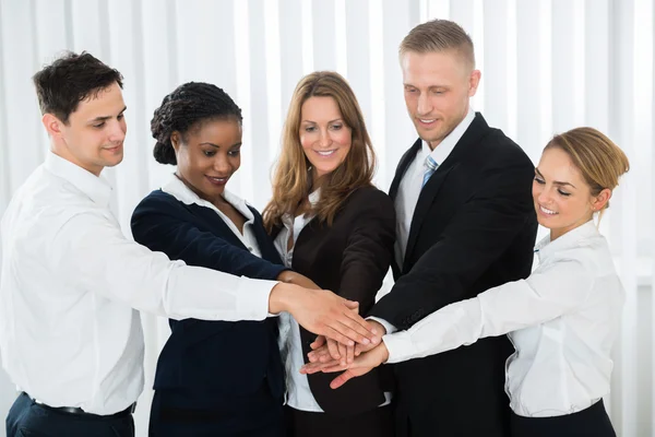 Businesspeople Stacking Hands Stock Image