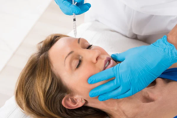 Mulher que recebe a injeção cosmética com seringa — Fotografia de Stock