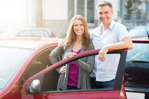 Happy Couple With New Red Car — Stock Photo, Image