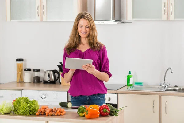 Woman Looking For Recipe On Digital Tablet — Stock Photo, Image